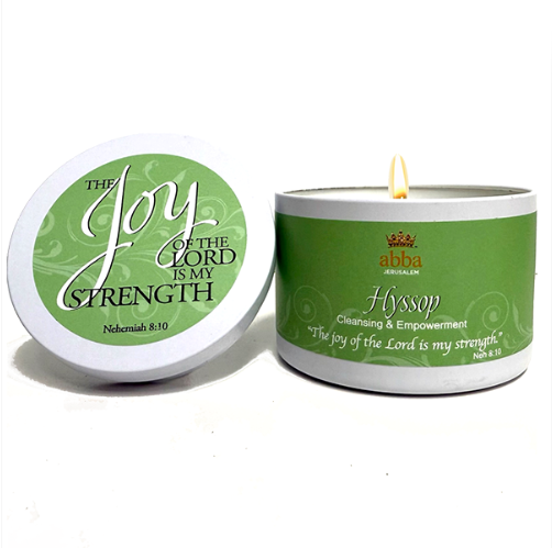 A white wax candle with a green label and matching lid, shown on a white background. The lid reads 'The Joy of the Lord is My Strength' and the candle container has a green label reading 'abbabreeds Hyssop Cleansing & Empowerment' with a small flame visible.